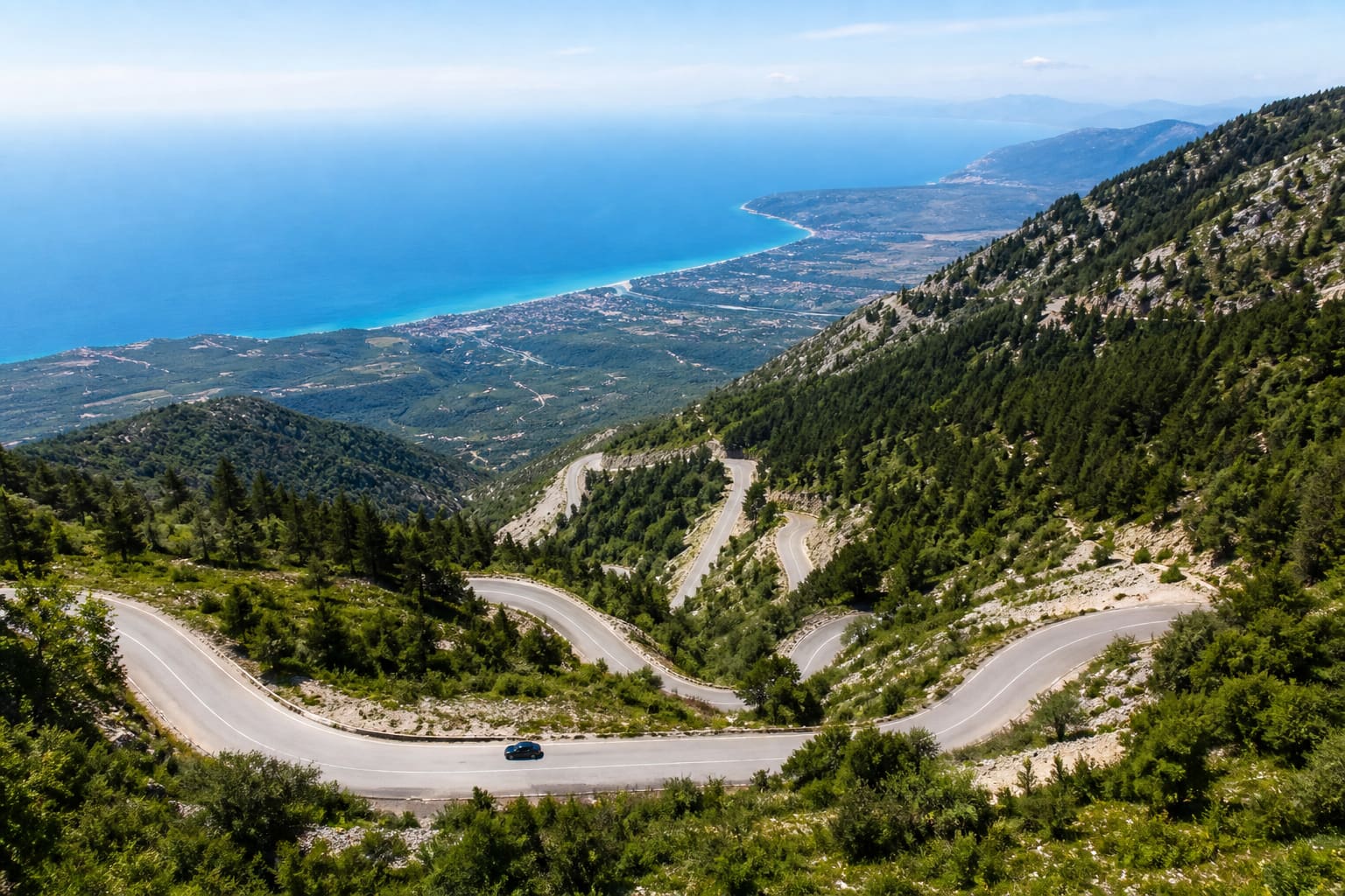 Hairpin bends above the Ionian Sea seen during Llogara Pass driving in Albania
